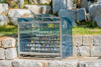 Closeup of prayer candles in glass cabinet on stone ledge in church countryside park in South Korea