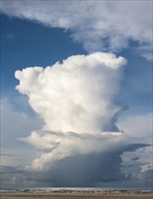 Rain cloud (Cumulonimbus capillatus) with heavy rain shower on the North Sea beach, Henne Molle,
