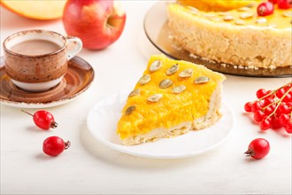 Traditional american sweet pumpkin pie decorated with hawthorn red berries and pumpkin seeds with