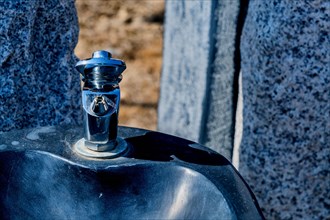 Closeup of drinking fountain in wilderness park on sunny winter day in South Korea