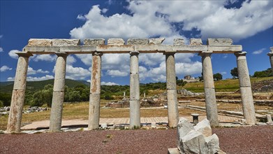 Ruins of ancient columns under a blue sky with fluffy clouds, Stoa of the Agora, Archaeological