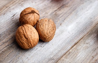 Walnuts on rustic wooden background with copy space