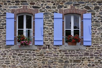 Two windows in a granite house, blue shutters, floral decoration, Pontrieux, Departement Cotes
