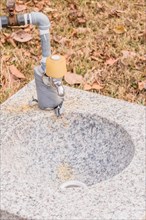 Closeup of outdoor water faucet and basin in public park in South Korea