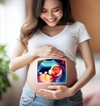 A pregnant young woman with the ultrasound image of her unborn baby in the womb, symbolic image