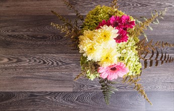 Bouquet of gerbera and chrysanthemum on a wooden background. floristic composition. copy space