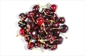 Pile of red sweet cherry isolated on white background. Top view