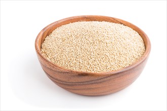 Wooden bowl with raw white quinoa seeds isolated on white background. Side view, close up