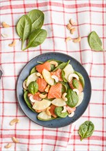 Fresh salmon with pineapple, spinach and cashew on a gray concrete background. Top view, flat lay,