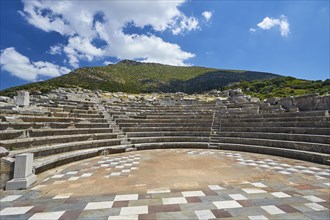 Sunny view of the ancient theatre with a view of the stage and the rows of seats, Asklepios