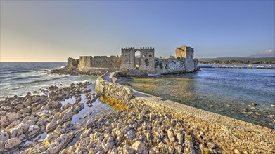 A picturesque old castle on the coast at sunset, sea fortress Methoni, Peloponnese, Greece, Europe