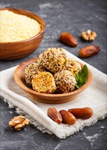 Energy ball cakes with dried apricots, sesame, cornflakes, linen, walnuts and dates with green mint