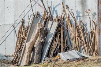 Scraps of wood and debris leaning against side of building in South Korea