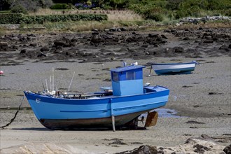 Fishing boats on the beach at low tide, Brittany, France, Europe