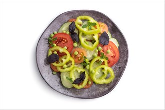 Vegetarian salad from green pea, tomatoes, pepper and basil isolated on white background. Top view,