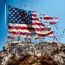 Symbolic image of a torn nation, the flag of the USA shreds in the wind and slowly disintegrates,
