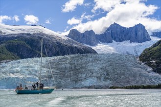 Sailing yacht between ice floes in Pia Bay in front of Pia Glacier, Alberto de Agostini National