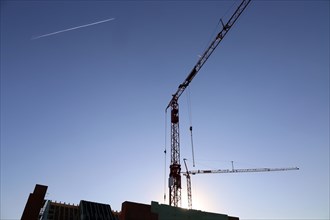Construction site with cranes at nightfall