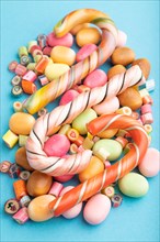 Various caramel candies on blue pastel background. close up, side view