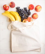 Fruits in reusable cotton textile white bag. Zero waste shopping, storage and recycling concept,