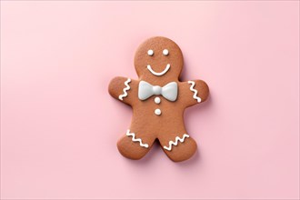 Christmas gingerbread man with bow tie on pink background. KI generiert, generiert AI generated