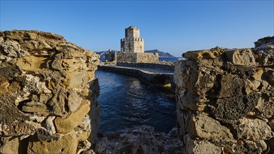 View through a crumbling bridge to a castle by the sea under a deep blue sky, octagonal medieval