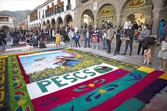 Peruvian people look at a floor painting in the Plaza de Armas, Ayacucho, Huamanga province, Peru,