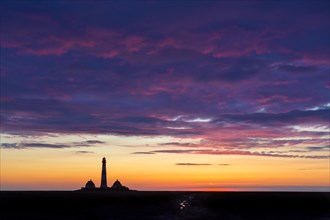 Lighthouse Westerheversand silhouetted against blue sunset sky, Westerhever, Wadden Sea National