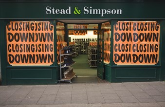 Stead and Simpson shoe shop closing down posters in window, Woodbridge, Suffolk, England, United
