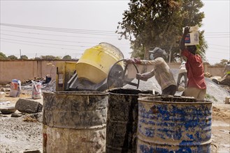 Young men working on a construction site in Nigeria, 06.02.2024