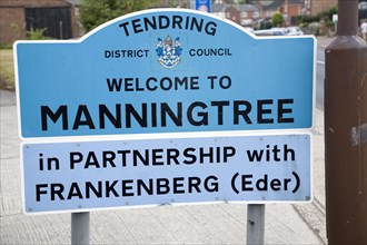 Road sign for the town of Manningtree, Tendring district council, Essex, England in partnership