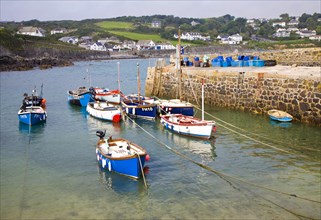 Small fishing boats in the harbour at the village of Coverack on the Lizard peninsula, Cornwall,