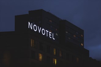 The Novotel hotel chain sign stands out in front of a block of flats in Berlin, 20/02/2024