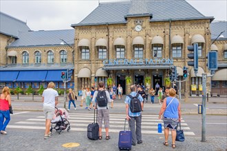 People at a pedestrian crossing on their way to the railway station to travel, Gothenburg, Sweden,
