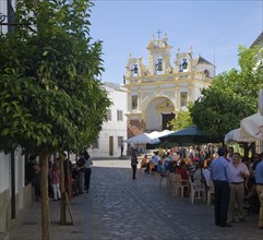 People gather in cafes and by the baroque church of San Juan at Zahara de la Sierra, Spain Sunday