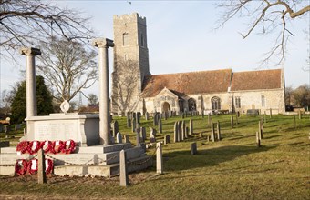 War memorial with poppy wreaths at St John the Baptists church, Snape, Suffolk, England, United