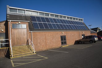 Rooftop array solar panels on community centre building, Woodbridge, Suffolk, England, United