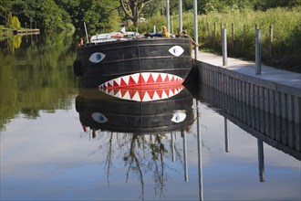 Boat on River Avon at Fladbury with a face painted on its bow, Worcestershire, England, United