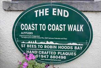 Sign showing the end of the Coast to Coast walk from St Bees to Robin Hoods Bay, England, United