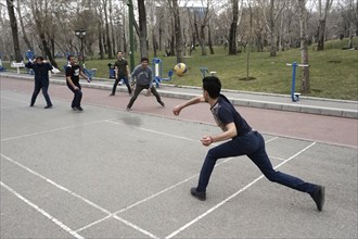 Men playing with a ball in a park in Tehran, Iran, 14/03/2019, Asia