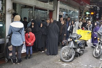 Shopping for the upcoming Persian New Year, queue in front of a butcher shop in a bazaar in Tehran,