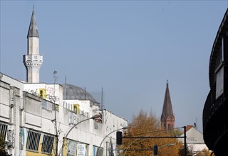 A church tower and the minaret of the Mevlana mosque in Berlin's Kreuzberg district, 12 October