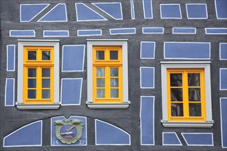 Yellow windows and blue half-timbering on half-timbered house, leaning, detail, blue, yellow, year,