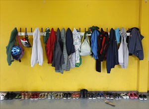 Jackets and bags hanging on a cloakroom in a Berlin primary school, shoes on the floor, 14/08/2019