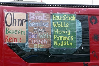 Poster with a list of agricultural products on a vehicle, farmers' protests, demonstration against