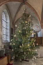 Christmas tree decorated with straw stars in St Egidienkirche, Beerbach, Middle Franconia, Bavaria,