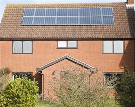 Photovoltaic solar panels on roof of modern suburban house, Martlesham, Suffolk, England, United
