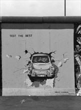 The Birgit-Kinder painting of the East Side Gallery with a GDR Trabant car and the inscription TEST