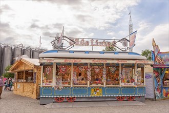 Folk festival and funfair stand, shape of Bavarian tram, almonds, sweets, children, moated castle