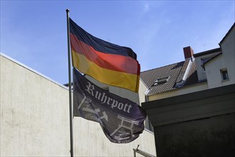 A German flag and a flag with the inscription Ruhrpott hanging on the flagpole of a house, Herne,